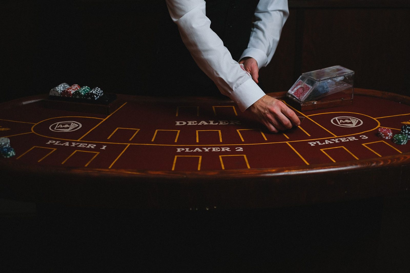 Croupier dealing cards at a gaming table